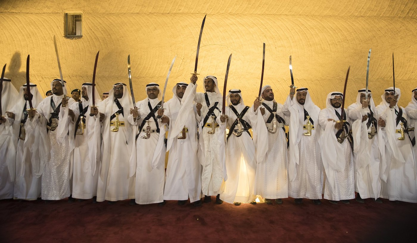 Arab men performing Al Ardah, a traditional Saudi Arabian folk dance and music - (Credits Arab News)