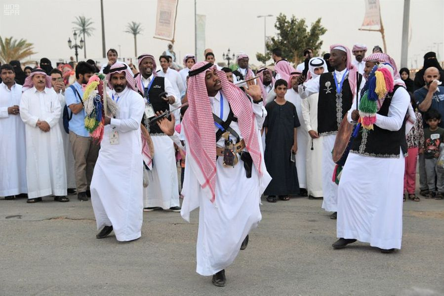 Saudi men performing a dance on traditional Saudi Arabian folk music - (Credits Wafy)