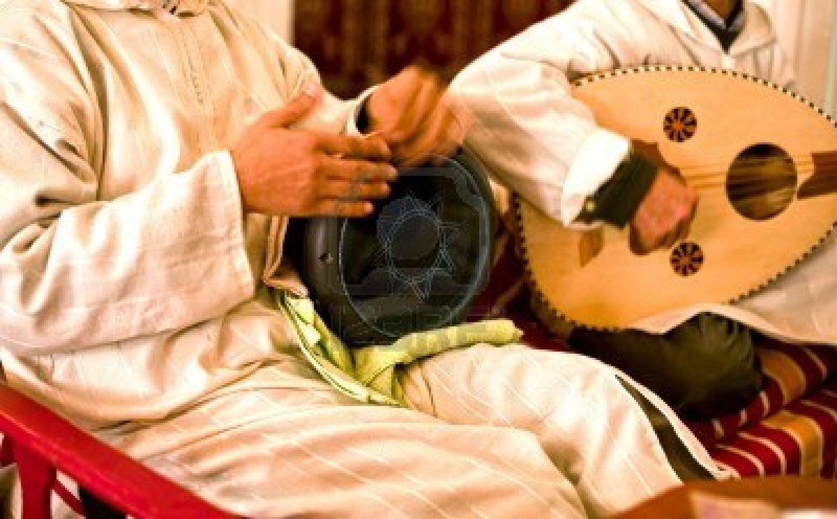 Two men playing folk music with traditional instruments - (Credits Islam In Indonesia)