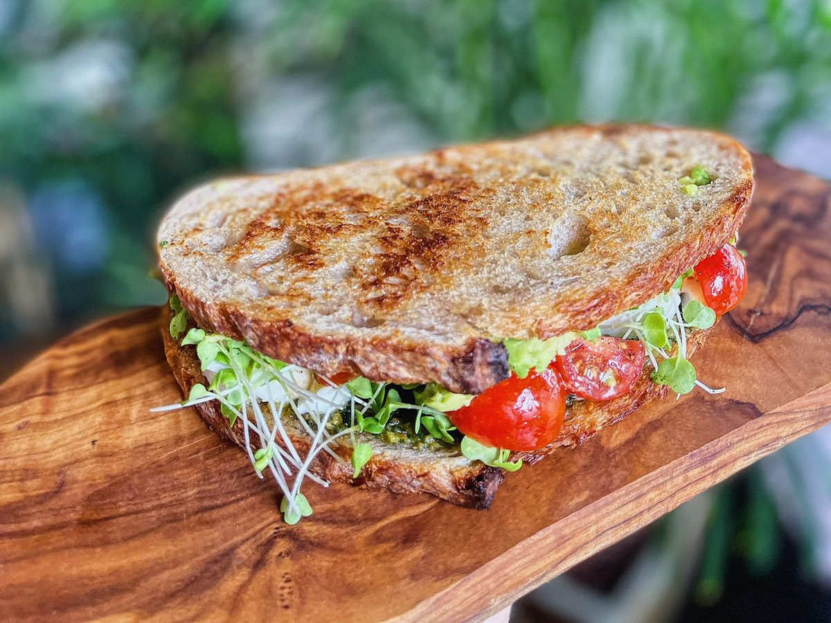 Delicious breakfast sandwich on a wooden tray - (Credits Time Out Riyadh)