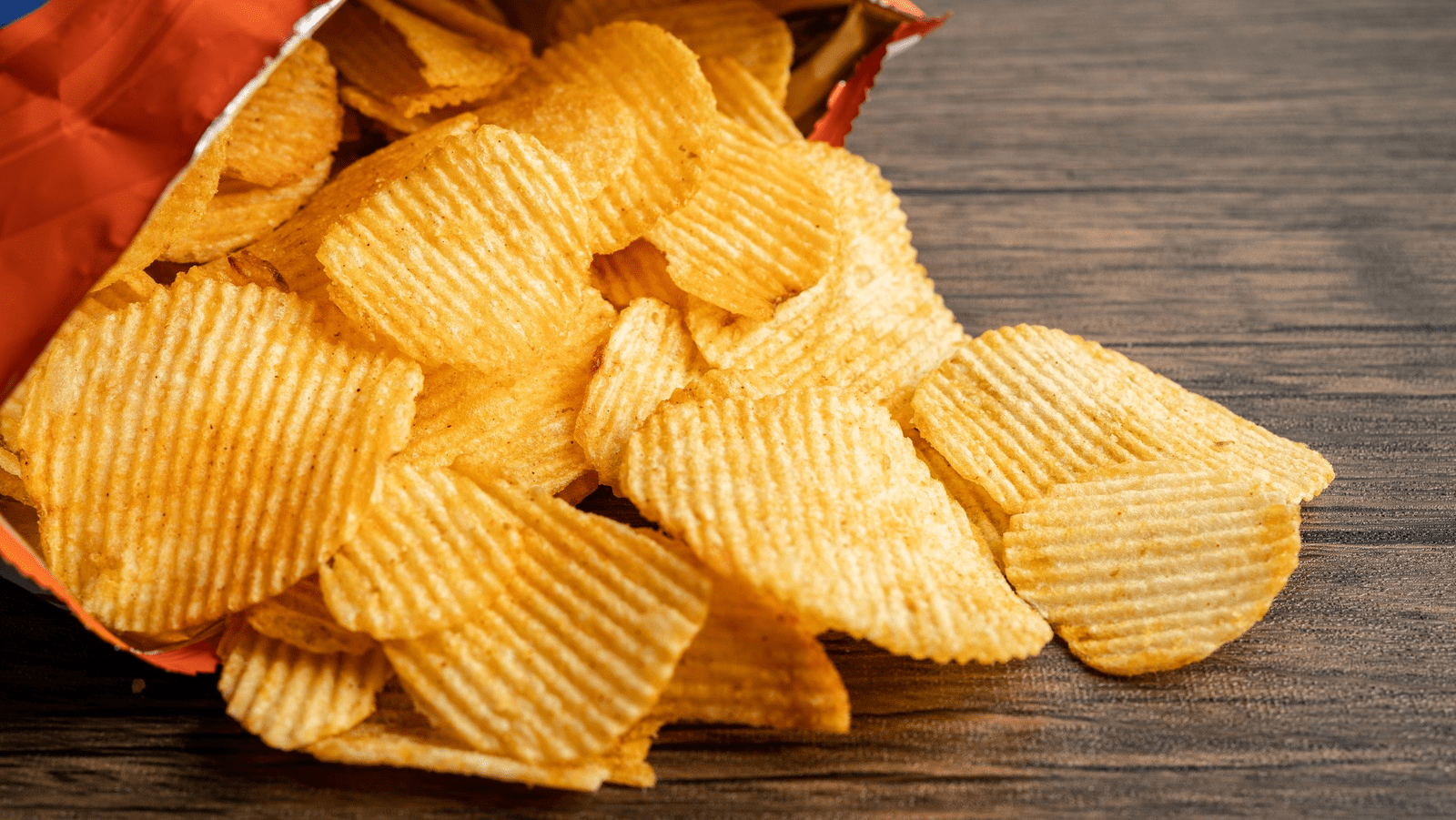 Crinkle chips pouring out of a bag - (Credits Potato Chips Production Line)